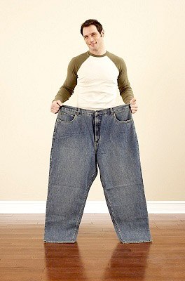 Man who lost weight in his big jeans.