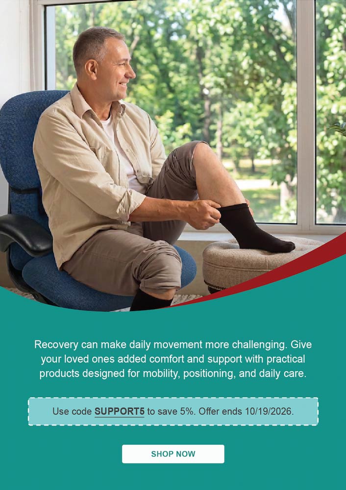 Use code SUPPORT5 to save 5%. Offer ends 10/19/2026. Man sitting in a chair putting on a black sock.